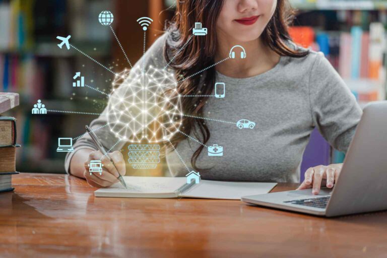 A woman writing in a notebook while sitting at a desk, with a laptop nearby. Holographic icons of a brain, devices, and technology-related symbols float above her notebook, representing AI and its applications in various fields