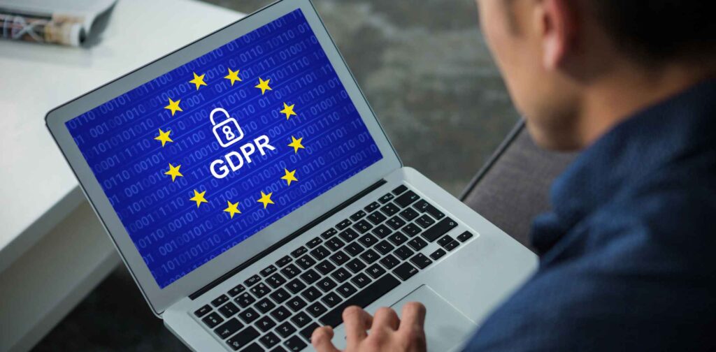 man looking at laptop screen containing the letters GDPR