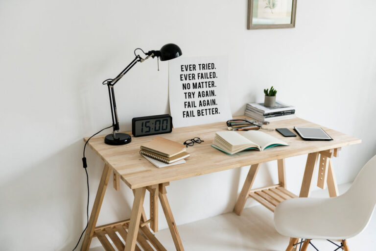 a desk with a motivational poster