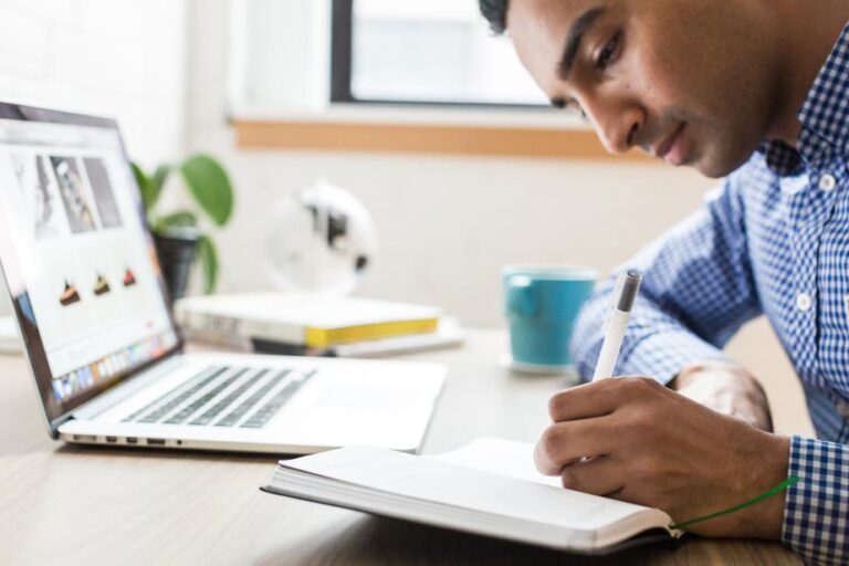 man studying and taking notes